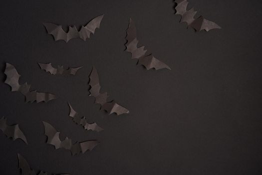 Halloween decoration concept black paper bats black cardboard background With copy space for tetxt