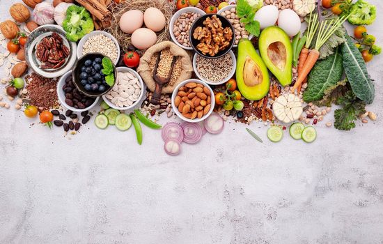 Ingredients for the healthy foods selection. The concept of superfoods set up on white shabby concrete background with copy space.