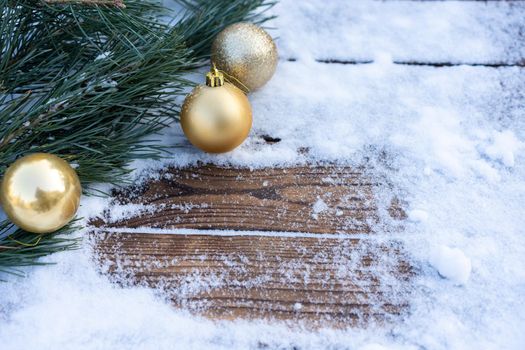 Winter background. Empty wooden plank with snowy border with pine branch and christmas ball decoration, copy space for text Wood table to. For product display Christmas time mock up