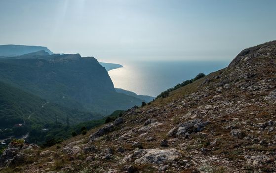 Mediterranean landscape. Forested rocks of the Black Sea coast of the southern coast of the Crimean Peninsula on a clear sunny day.