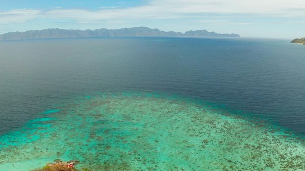 aerial view tropical island with sand white beach. Bulog Dos, Philippines, Palawan. Seascape bay with turquoise water and coral reef.