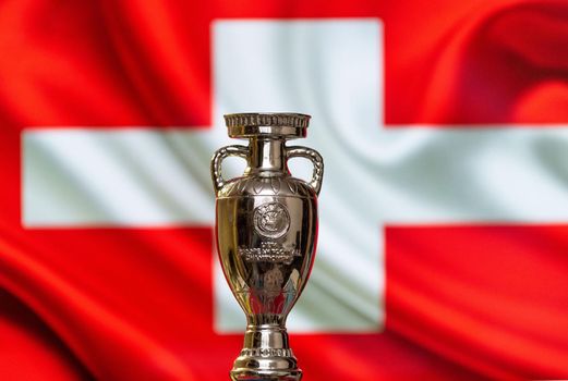 April 10, 2021. Geneva, Switzerland. UEFA European Championship Cup with the Swiss flag in the background.