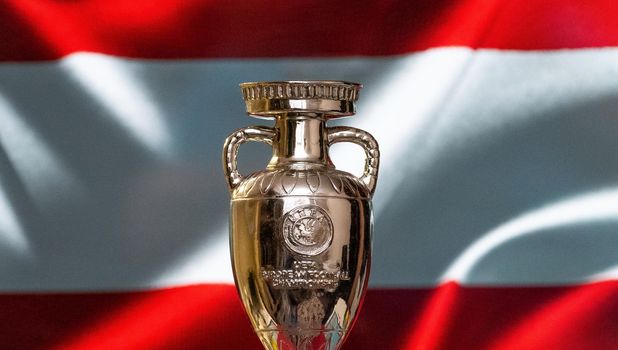 April 10, 2021. Vienna, Austria. UEFA European Championship Cup with the Austrian flag in the background.