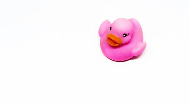 Pink rubber duck with orange beak isolated on a white background. Baby bath and shower for children. Toys and fun for children