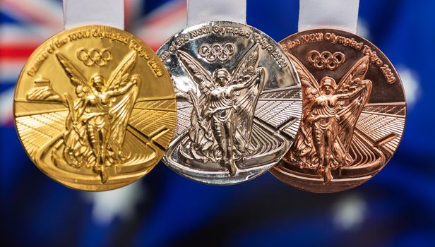 April 25, 2021 Tokyo, Japan. Gold, silver and bronze medals of the XXXII Summer Olympic Games 2020 in Tokyo on the background of the flag of Australia.
