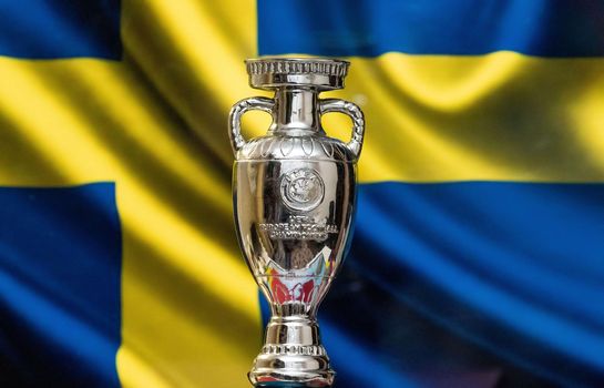 April 10, 2021. Stockholm, Sweden. UEFA European Championship Cup with the Swedish flag in the background.
