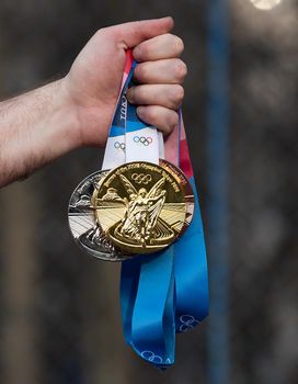 April 17, 2021 Tokyo, Japan. Gold, silver and bronze medals of the XXXII Summer Olympic Games in Tokyo in the hand of an athlete.