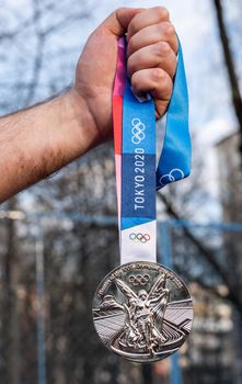 April 17, 2021 Tokyo, Japan. Silver medal of the XXXII Summer Olympic Games in Tokyo in the hand of an athlete.