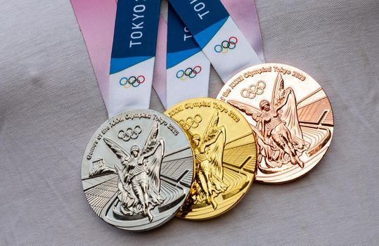 April 17, 2021 Tokyo, Japan. Gold, silver and bronze medals of the XXXII Summer Olympic Games in Tokyo on the chest of the athlete.