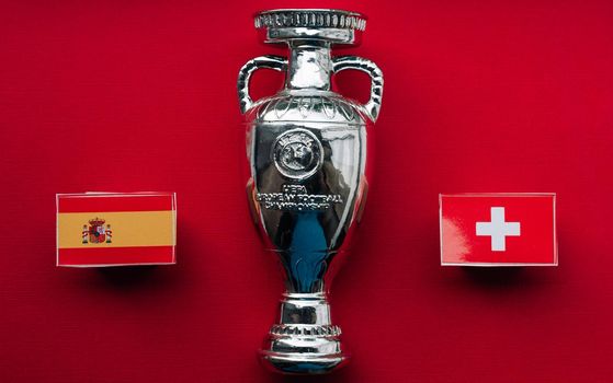 July 1, 2021 St. Petersburg, Russia Flags of the European Football Championship 1/4 finals Spain and Switzerland against the backdrop of the Euro 2020 Cup.