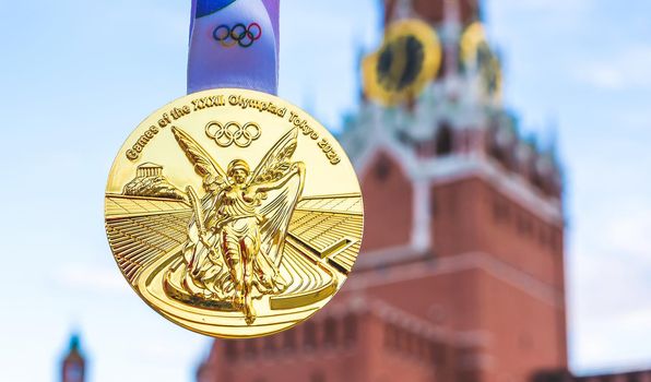 April 25, 2021, Moscow, Russia. Gold medal at the XXXII Summer Olympic Games, which will be held in Tokyo, against the backdrop of the Spasskaya Tower of the Moscow Kremlin.