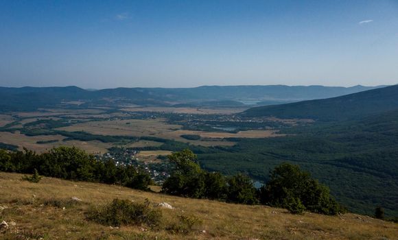 Mediterranean landscape. Forested rocks of the Black Sea coast of the southern coast of the Crimean Peninsula on a clear sunny day.