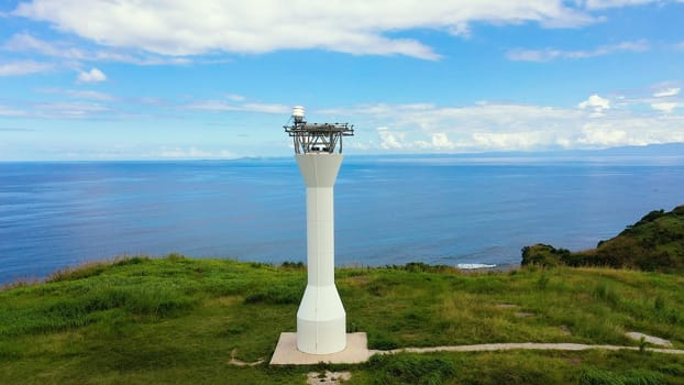 Basot Island, Caramoan, Camarines Sur, Philippines. Lighthouse on a tropical island. Lighthouse on the hill. Beautiful landscape with a green island. Summer and travel vacation concept.
