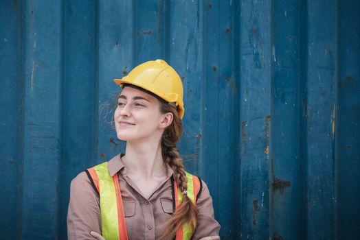 Portrait of Confident Transport Engineer Woman in Safety Equipment Standing in Container Ship Yard. Transportation Engineering Management and Containers Logistics Industry, Shipping Worker Occupation