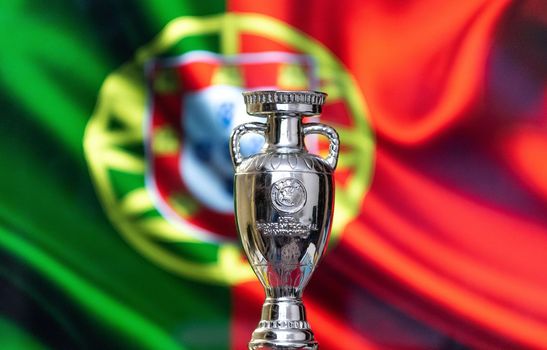 April 10, 2021. Lisbon, Portugal. UEFA European Championship Cup with the Portuguese flag in the background.