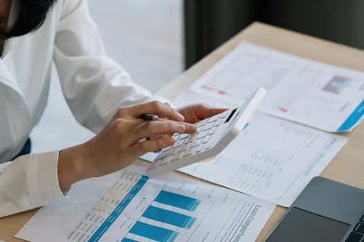 Close up busy woman using calculator, renter checking bills, planning budget, sitting at desk with financial documents and receipts, accounting expenses, calculating money, rent or mortgage payment