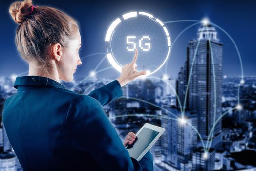 Technology Innovation 5G Networking System Concept, Business Woman Pressing 5G Button Media Interface on Virtual Screen and City Communication Network. Global Futuristic and Internet of Things