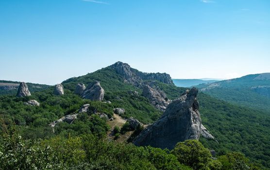 Mediterranean landscape. Forested rocks of the Black Sea coast of the southern coast of the Crimean Peninsula on a clear sunny day.