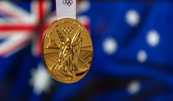 April 25, 2021 Tokyo, Japan. Gold medal of the XXXII Summer Olympic Games 2020 in Tokyo on the background of the flag of Australia.