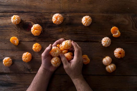 Presentation of Small peeled mandarin oranges on old wooden table