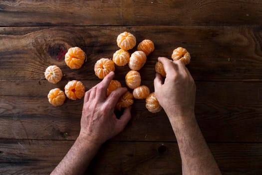 Presentation of Small peeled mandarin oranges on old wooden table