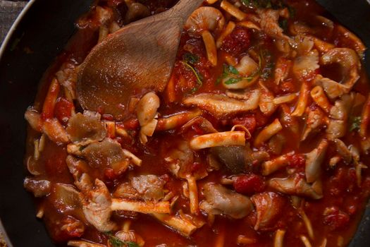 Preparation of a mushroom soup pioppini with tomato base