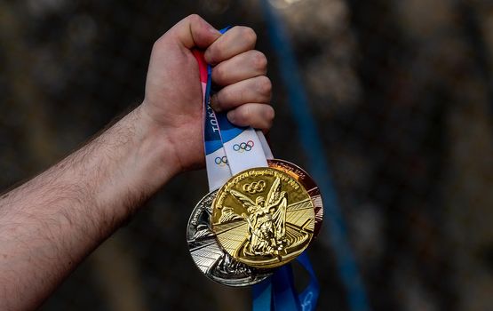 April 17, 2021 Tokyo, Japan. Gold, silver and bronze medals of the XXXII Summer Olympic Games in Tokyo in the hand of an athlete.