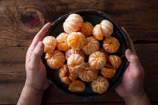 Presentation of Small peeled mandarin oranges on old wooden table