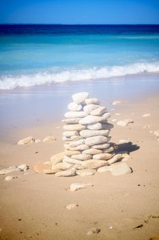 Pile of stone on the beach on the lighthouse Phare des Baleines on the isle of Ile de Ré in France on a sunny summerday