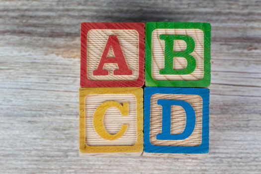 ABCD wooden block alphabet puzzle on wood background