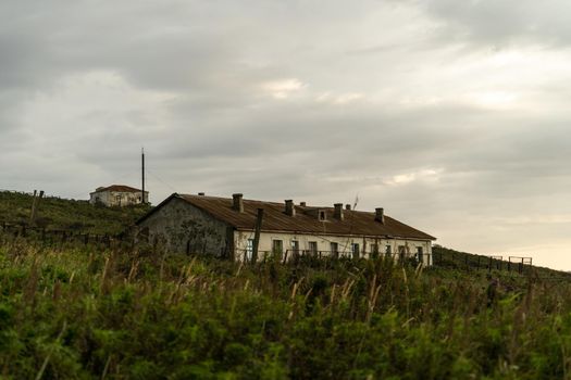 Landscape with old abandoned houses. Cape Pospelova, Primorsky Krai