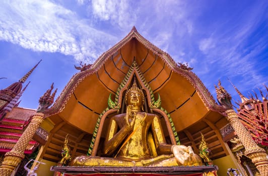 Big gold buddha statue and blue sky