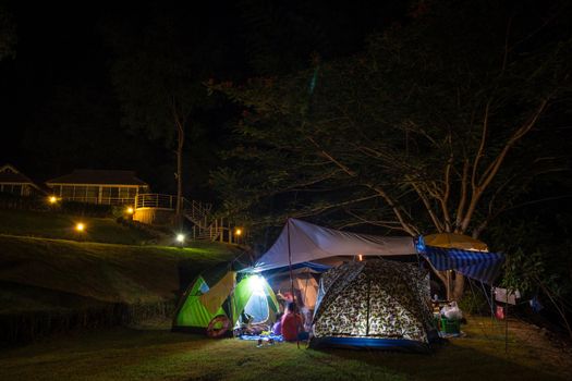 Camping and tent in the park at night