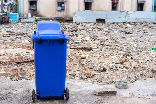 blue trashcan with old building background