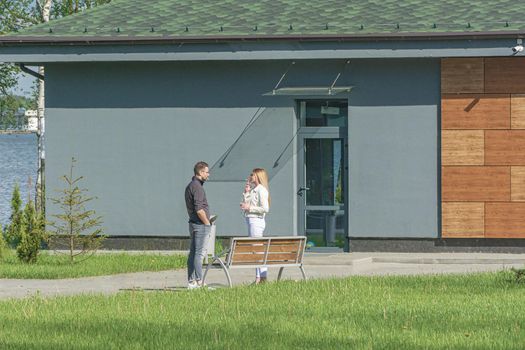 BELARUS, MINSK - MAY 23, 2021: A man and a woman smoke in the street. Stock photography.