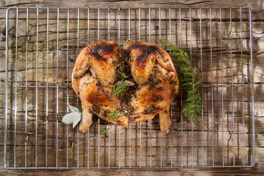 Presentation of a marinated chicken with herbs and baked in the oven