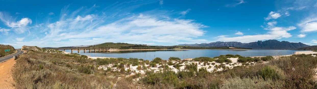 Panoramic view of the Theewaterskloof Dam in the Western Cape Province as seen from road R45. A road bridge is visible