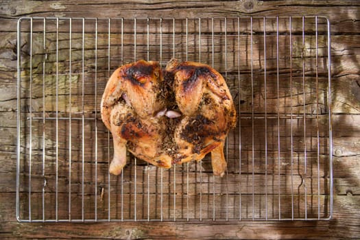 Presentation of a marinated chicken with herbs and baked in the oven