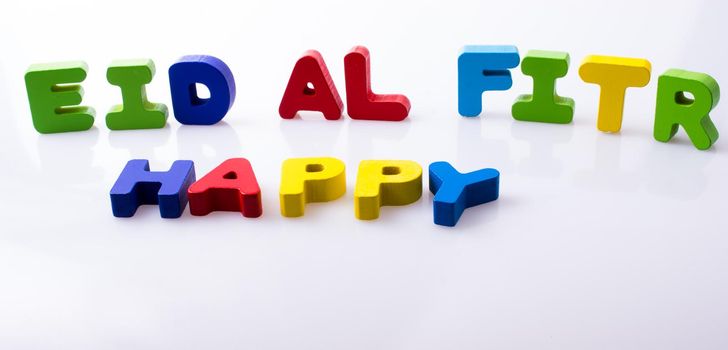 the word EID EL FITR  written with colorful letter blocks