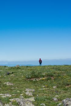 Young man  taking an excursion on a mountain