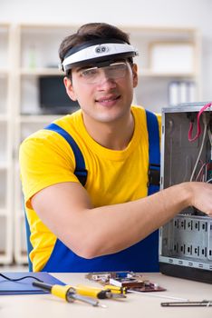 Computer repair technician repairing hardware
