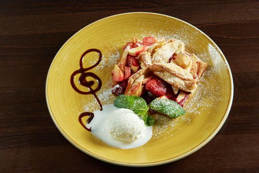 Melody of taste. Top view of a freshly baked fruit strudel served with ice cream