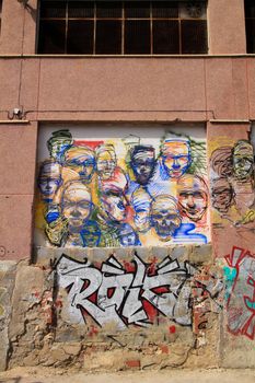 Elche, Alicante, Spain- February 27, 2021: Beautiful and colored graffiti on the stone wall of a abandoned factory in Elche, Alicante, Spain