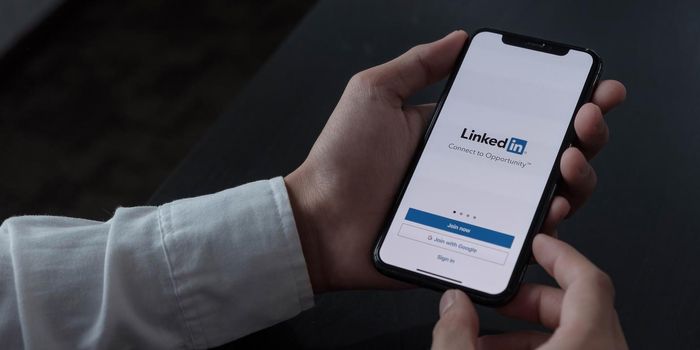 CHIANG MAI, THAILAND, DEC 12, 2020 : A women holds Apple iPhone Xs with LinkedIn application on the screen.LinkedIn is a photo-sharing app for smartphones..