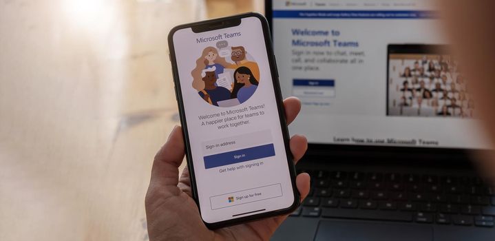 CHIANG MAI, THAILAND - APR 11, 2021 : A working from home employee is downloading the Microsoft Teams social platform, ready for remote working in isolation from home.