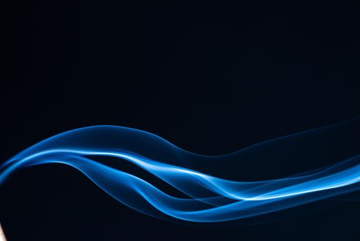 Blue smoke isolated on black background.