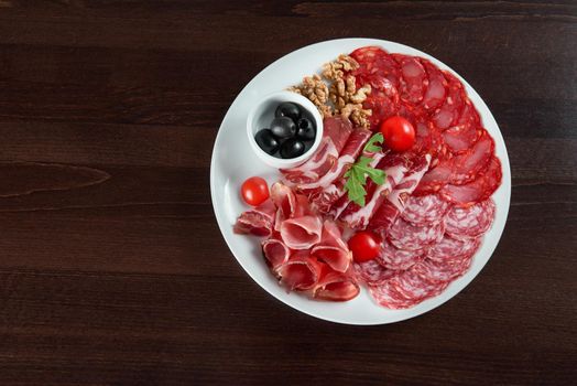 Salami love. Top view of a delicious salami and ham meat plate at the restaurant copyspace