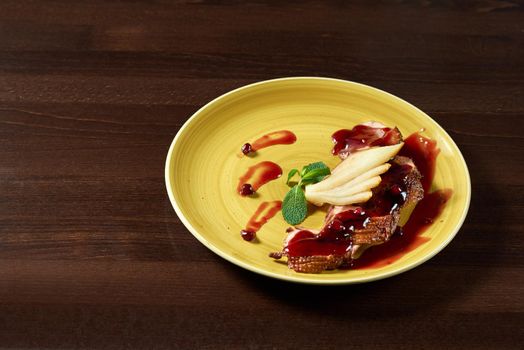 Cranberries sauce with sliced duck meat. Shot of a sliced duck meat served with pears under cranberries sauce