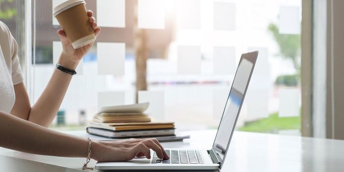 Close up hands of female employee using laptop at workplace, looking at screen, businesswoman preparing economic report, working online project, cheerful intern doing computer work, typing..