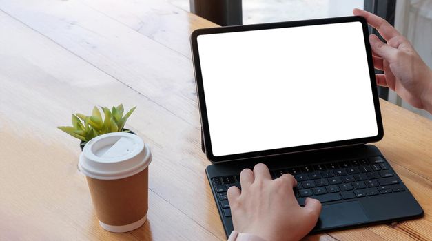 women using laptop computer working at home with blank white desktop screen..